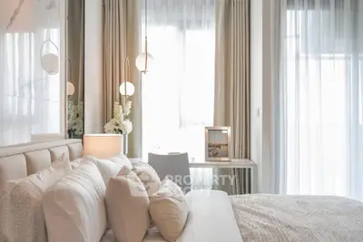 Luxurious bedroom with elegant decor and soft lighting, featuring plush bedding and stylish accents.