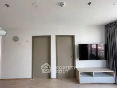 Modern living room with wall-mounted TV and minimalist decor