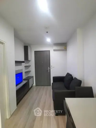 Modern living room with sleek furniture and wooden flooring