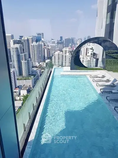 Luxurious rooftop pool with stunning city skyline view in modern high-rise building.