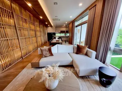 Luxurious modern living room with elegant wooden accents and large windows offering serene garden views.
