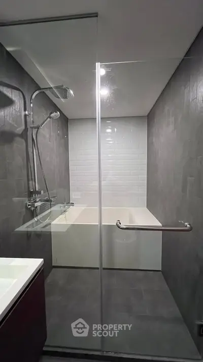 Modern bathroom with sleek glass shower and elegant bathtub