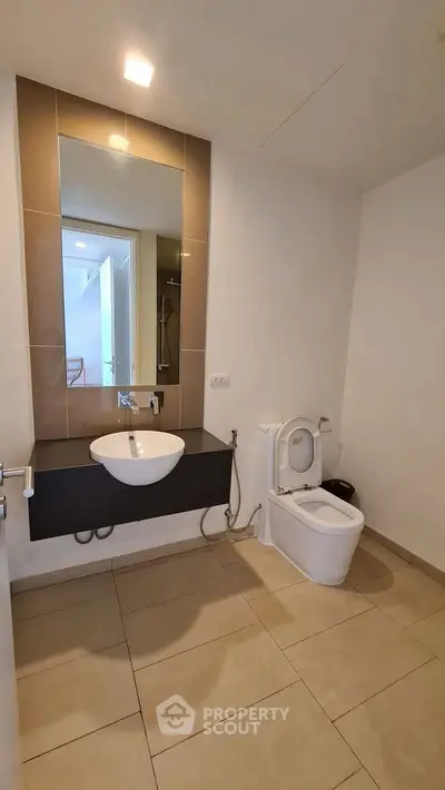 Modern bathroom with sleek design and large mirror