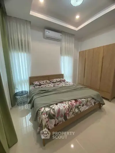 Cozy bedroom with modern design and ample natural light