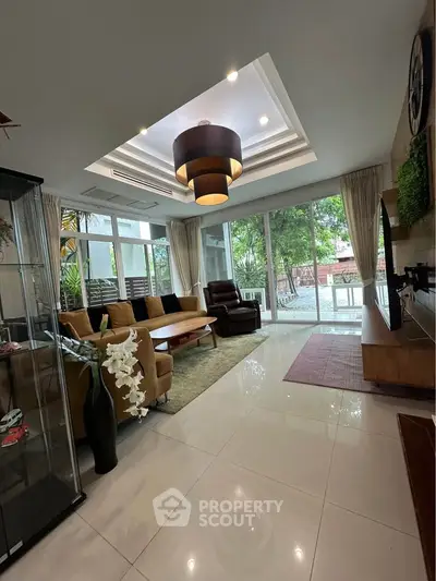 Spacious modern living room with large windows and stylish decor
