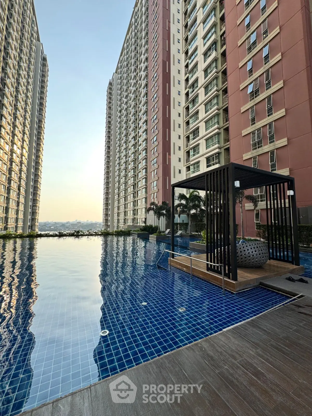 Luxurious high-rise apartment complex with stunning poolside view and modern amenities.