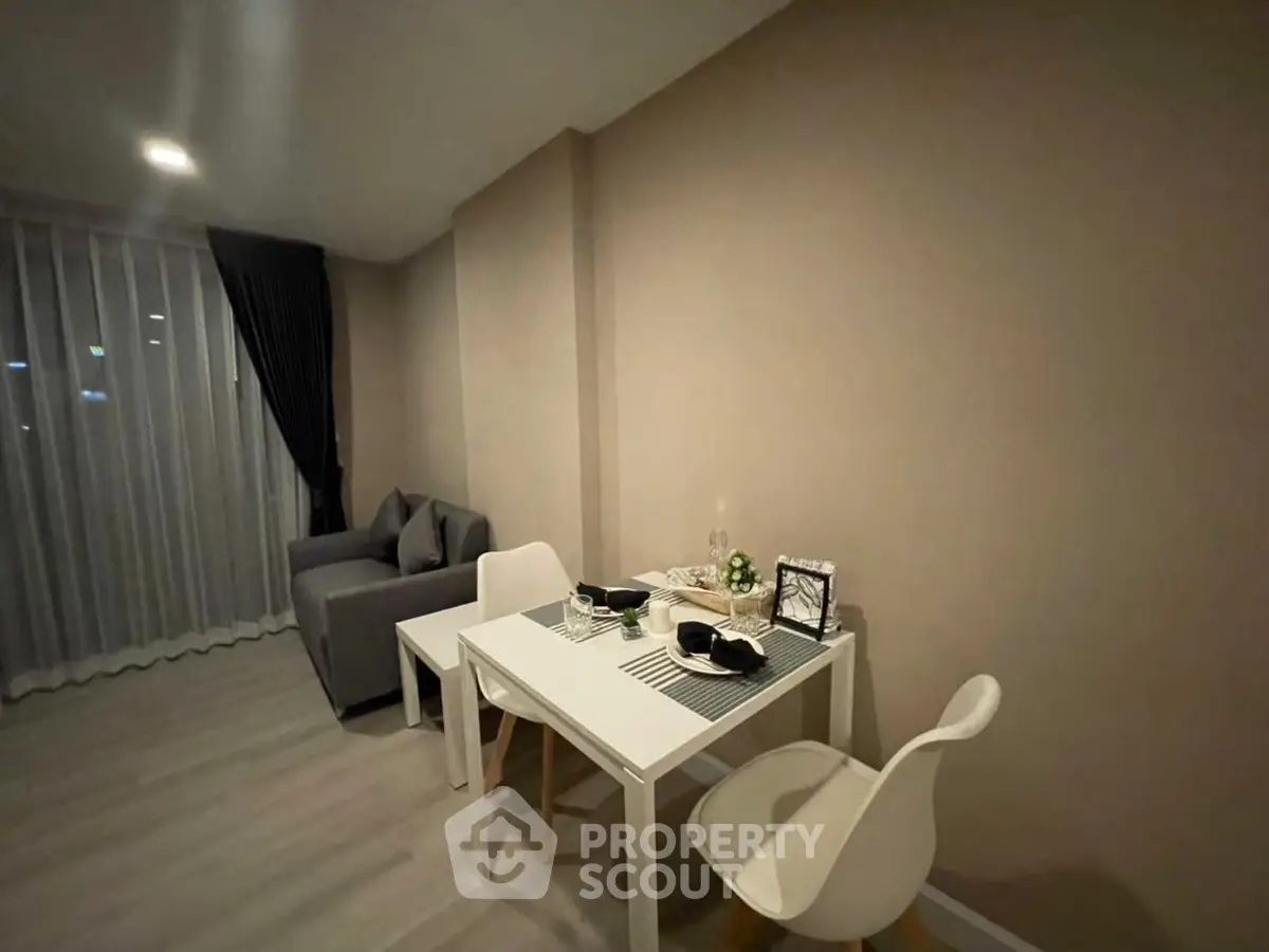 Cozy modern living room with dining area, featuring stylish furniture and elegant decor.