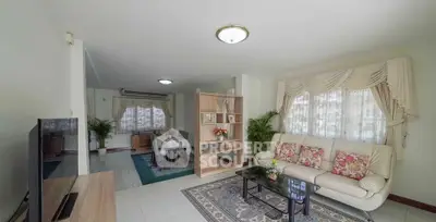 Spacious living room with elegant decor and natural light, perfect for family gatherings.