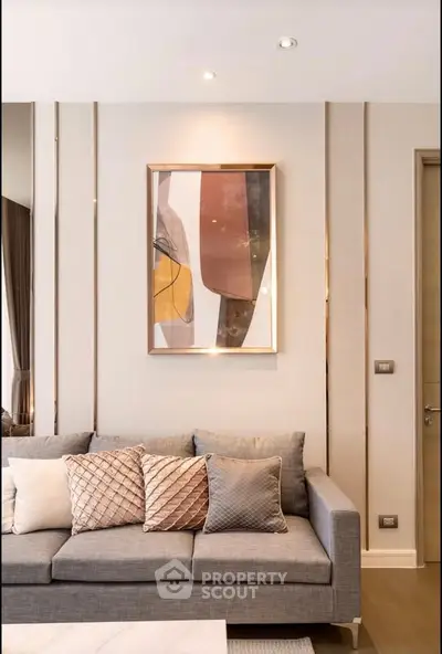 Elegant living room with modern sofa and abstract art, perfect for stylish urban living.