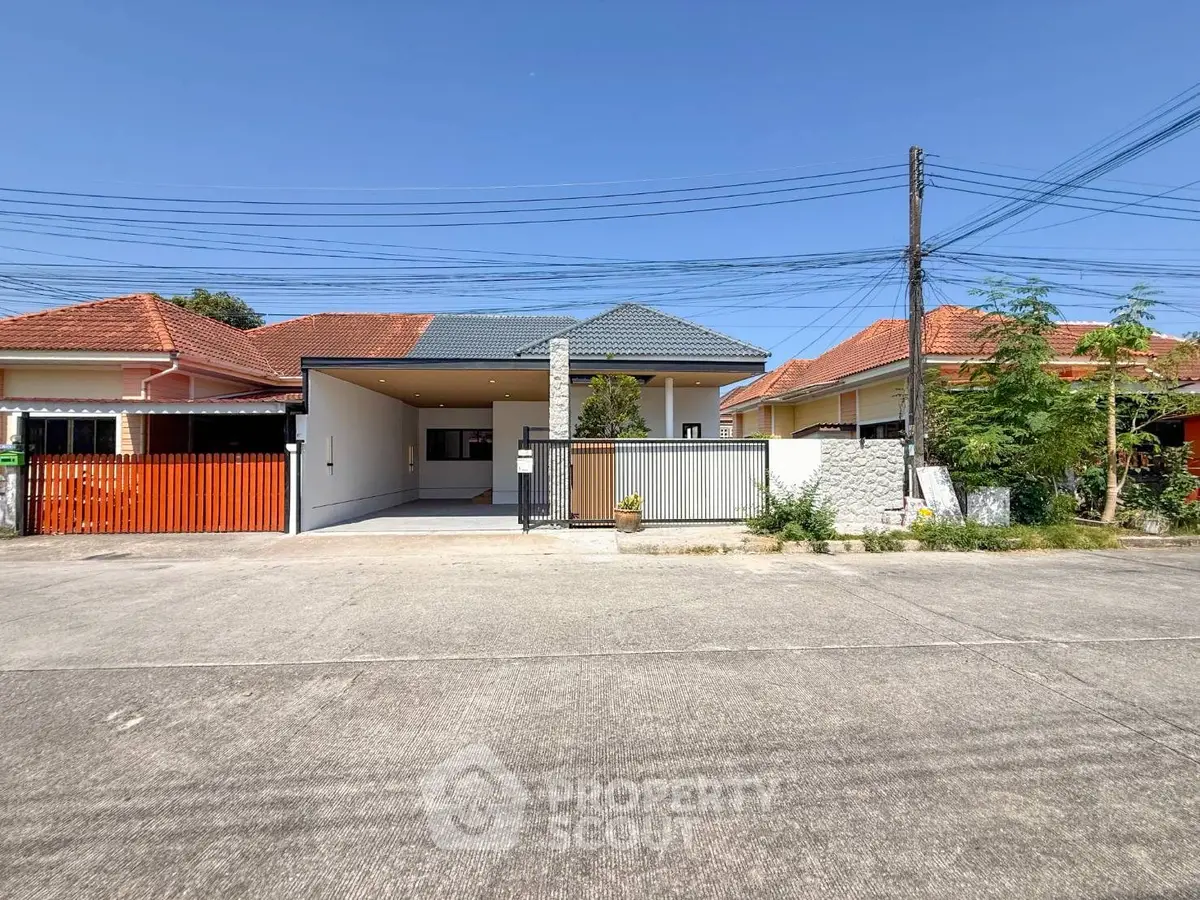 Charming single-story house with modern design and spacious driveway in a serene neighborhood.