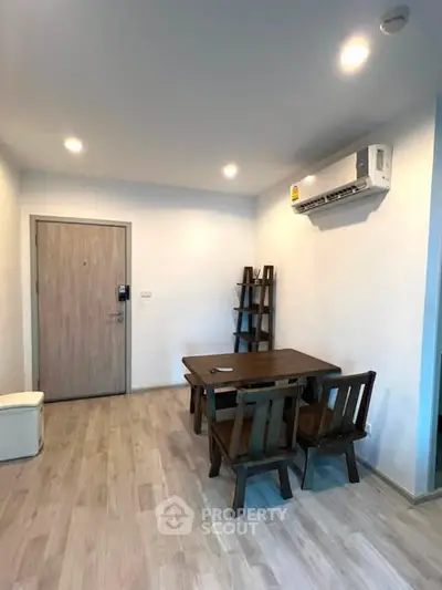 Modern living room with wooden furniture and air conditioning in a cozy apartment.