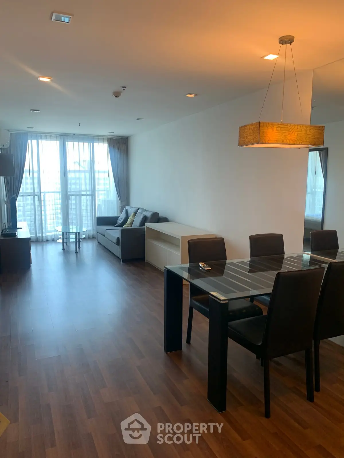 Spacious modern living room with dining area and large windows