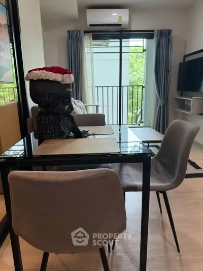 Modern living room with sleek furniture and balcony view, perfect for urban living.