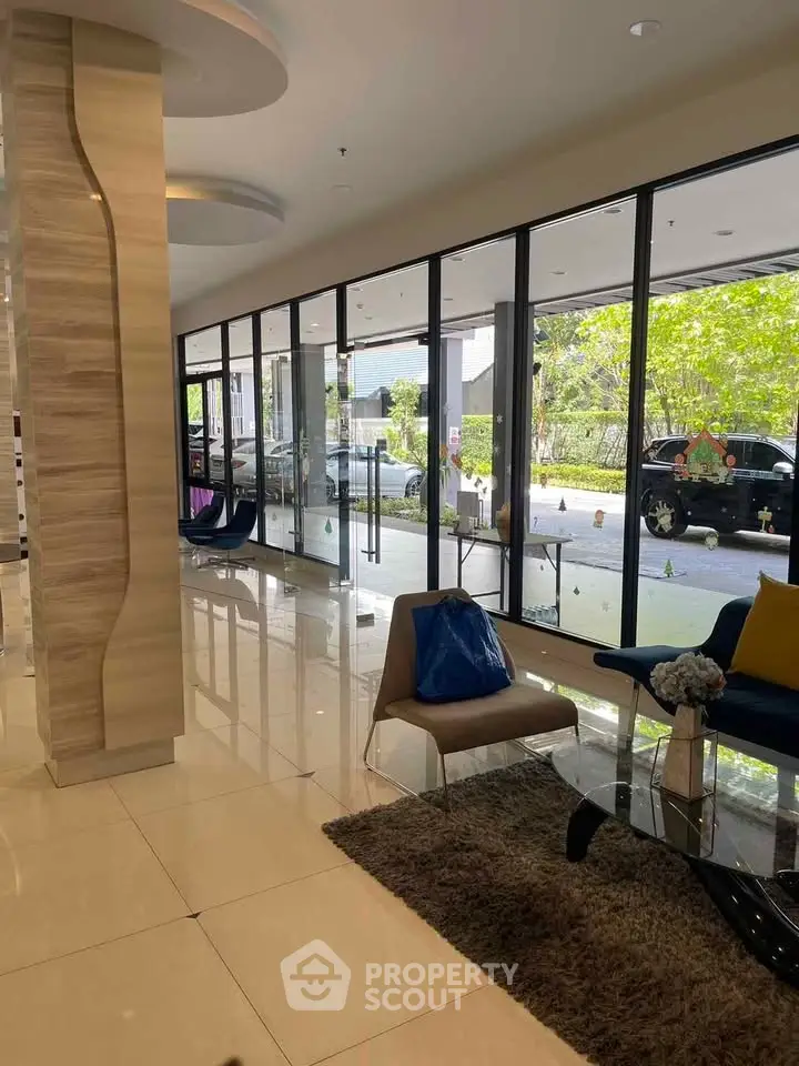 Elegant lobby with modern seating and large windows offering natural light and garden views.
