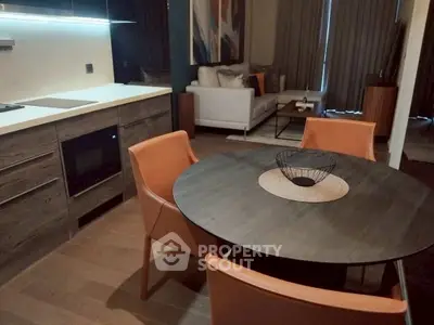 Modern open-layout kitchen and living room with stylish furniture and decor