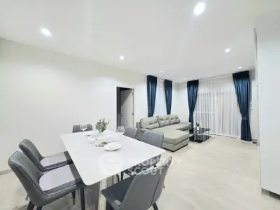 Spacious modern living room with elegant dining area and cozy seating, perfect for entertaining guests.