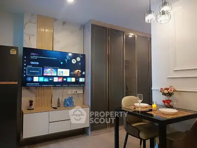 Modern living room with elegant dining area and wall-mounted TV
