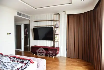 Spacious modern living room with wall-mounted TV and elegant decor