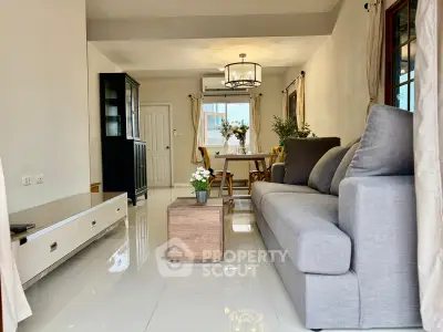 Spacious living room with modern decor and elegant dining area, perfect for family gatherings.
