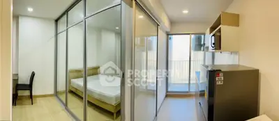Modern apartment interior with glass partition, bedroom and kitchen area
