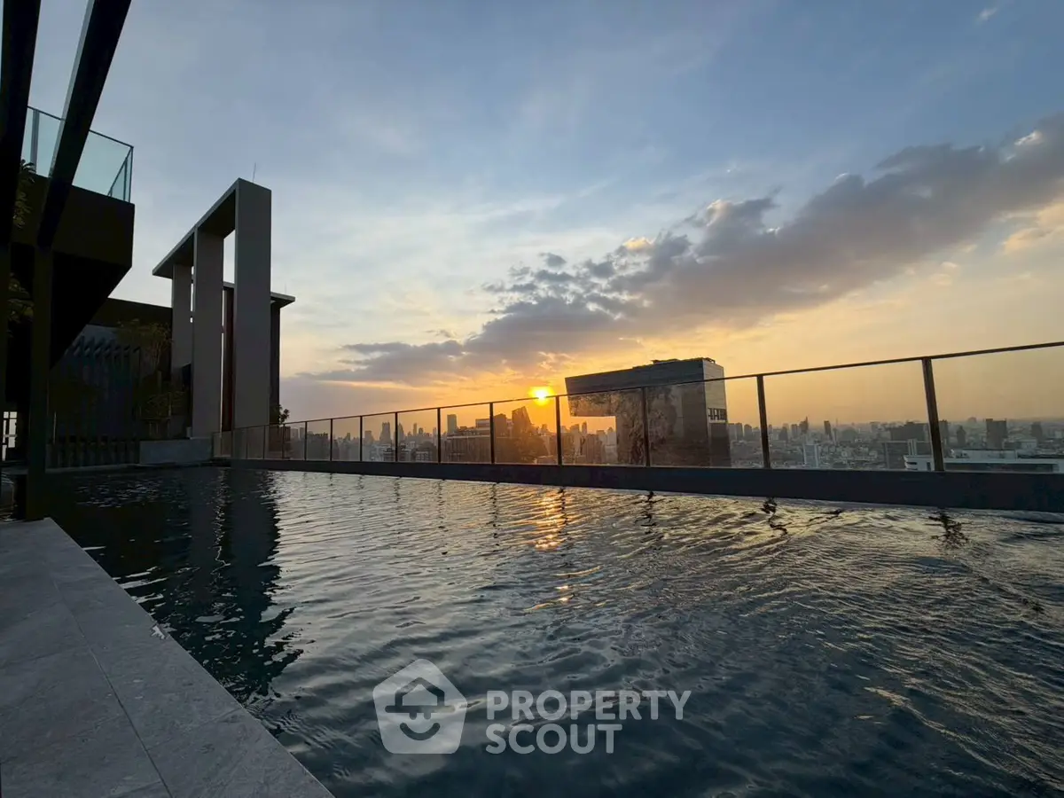 Stunning rooftop pool with breathtaking city skyline view at sunset