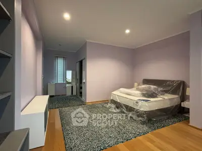Spacious bedroom with modern decor and natural light