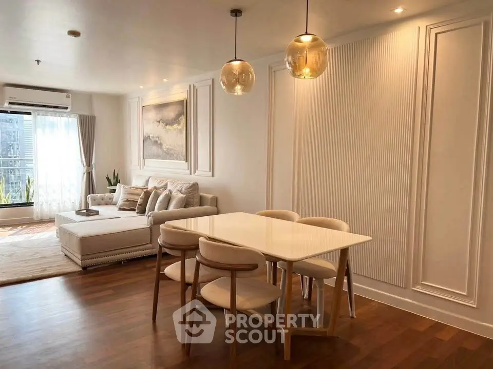 Elegant living room with modern dining area and stylish lighting