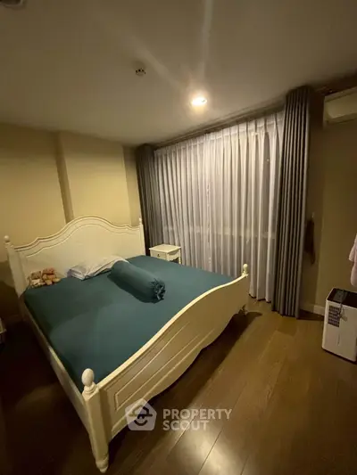 Cozy bedroom with elegant bed and soft lighting, perfect for relaxation.