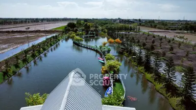 Stunning aerial view of serene landscaped garden with water feature and lush greenery, perfect for relaxation.