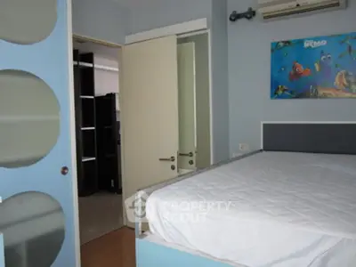 Modern bedroom with blue accents and wall art, featuring a comfortable bed and sleek design.