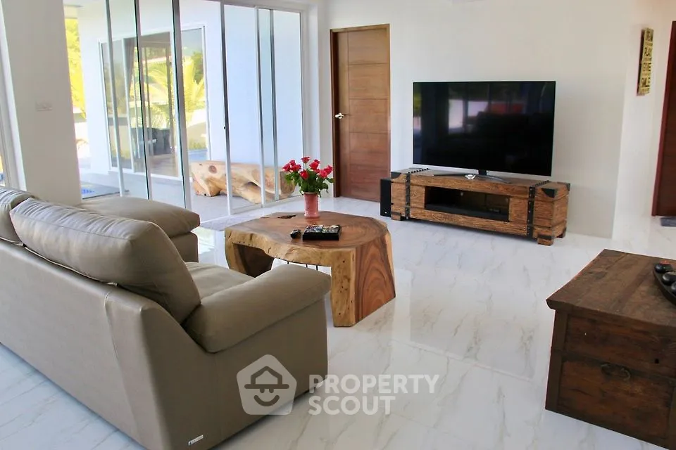 Spacious modern living room with large TV and stylish wooden furniture