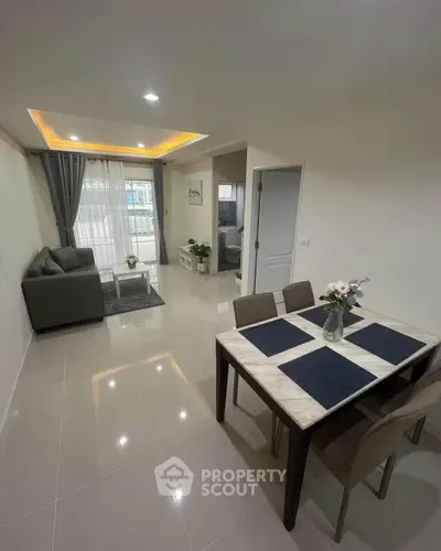 Modern living and dining area with sleek furniture and bright lighting