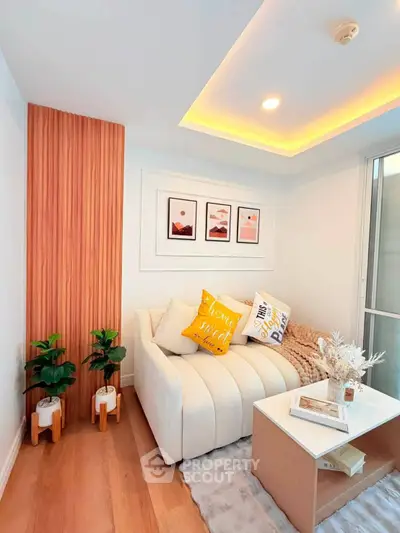 Stylish modern living room with cozy sofa, decorative pillows, and elegant wall art in a bright interior.