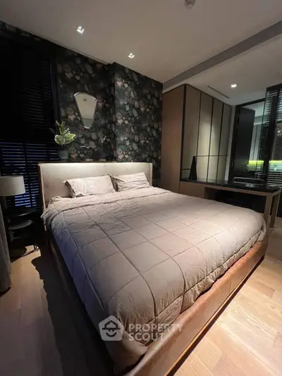 Luxurious bedroom with elegant decor and cozy ambiance, featuring a plush bed and stylish wallpaper.