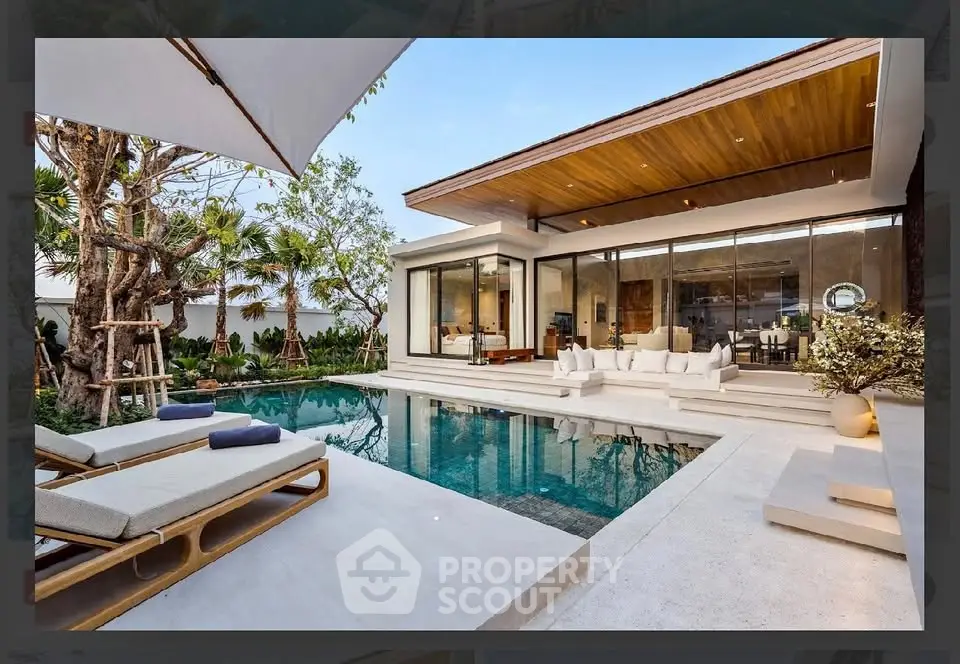 Luxurious modern villa with private pool and spacious outdoor lounge area, perfect for relaxation.