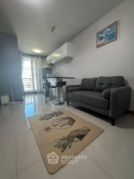 Modern living room with sleek sofa and stylish decor in a bright apartment.