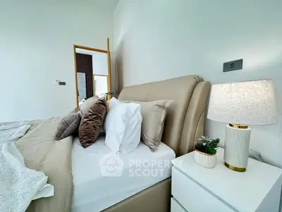 Luxurious bedroom with elegant decor and plush bedding in modern real estate property.