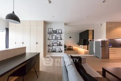 Modern open-plan living room with sleek kitchen and stylish decor