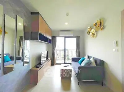 Modern living room with stylish decor and balcony access in a contemporary apartment.