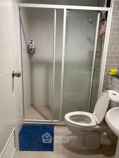 Modern bathroom with glass shower enclosure and white fixtures