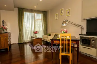 Charming living room with elegant decor and city view, featuring hardwood floors and cozy seating area.
