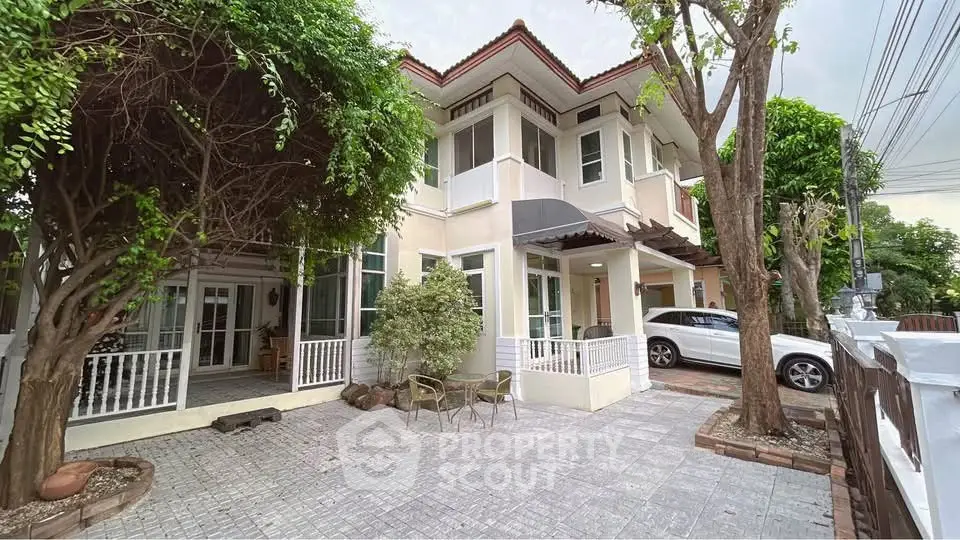 Charming two-story house with spacious driveway and lush greenery