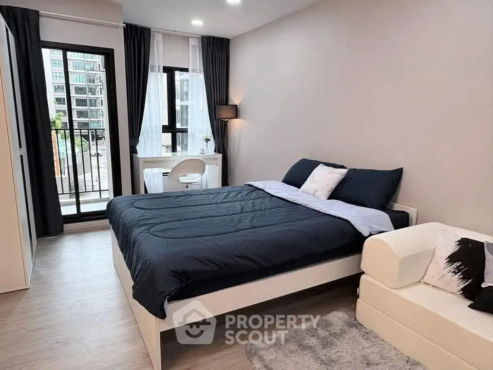 Modern bedroom with balcony access in urban apartment, featuring stylish decor and natural light.