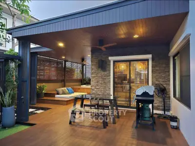 Stunning outdoor patio with modern seating and barbecue area, perfect for entertaining guests.