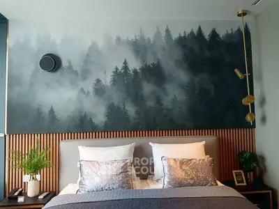 Luxurious bedroom with forest-themed wall art and elegant decor