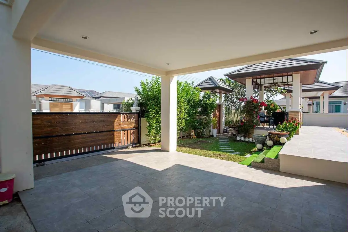 Spacious modern patio with garden and stylish pergola in a serene residential area.