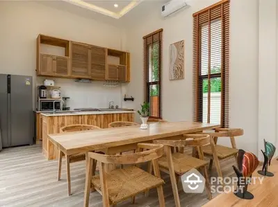 Spacious kitchen with wooden dining set and modern appliances