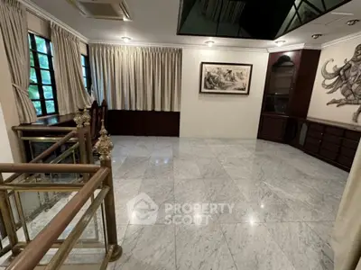 Elegant marble-floored room with luxurious decor and art, perfect for sophisticated living.
