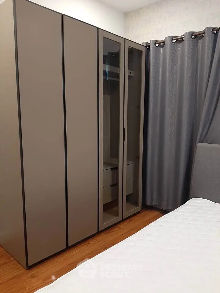 Modern bedroom with sleek wardrobe and cozy bed, perfect for stylish living.