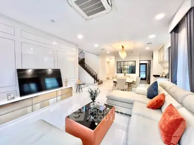 Luxurious open-plan living room with modern decor and elegant lighting